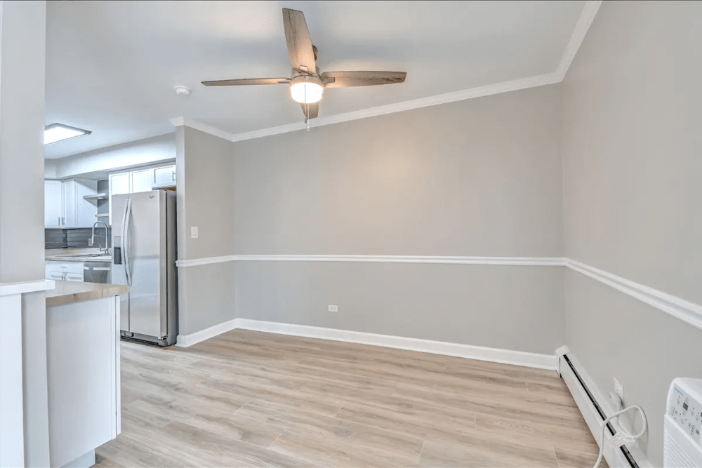 View of kitchen from dining area at Terraces of Elk Grove in Elk Grove Village, Illinois