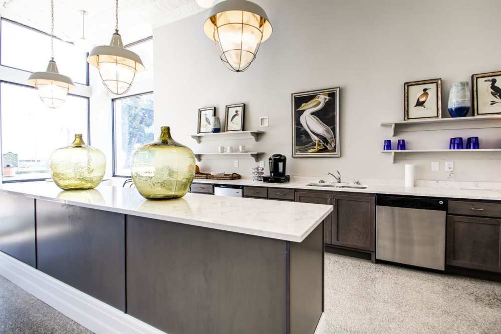 Modern kitchen with granite countertops, stainless steel appliances, and stylish pendant lights at Lloyd House II in Menominee, Michigan