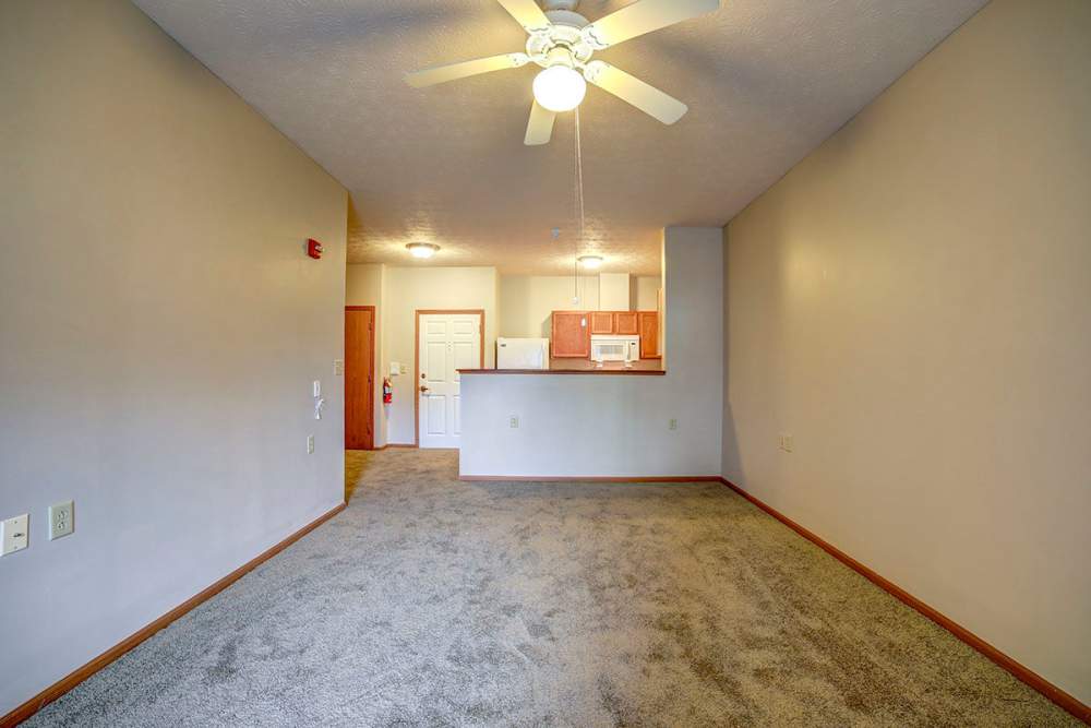 Apartment with open kitchen and ceiling fan at Brentwood Greene in Kokomo, Indiana