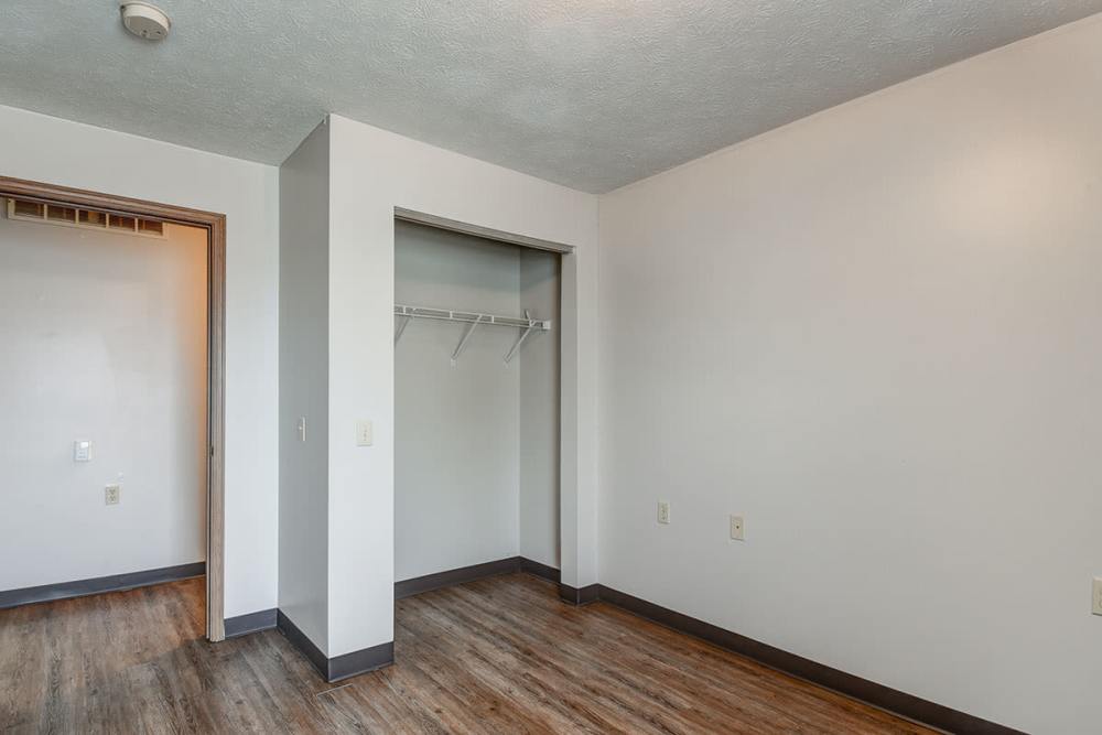 Spacious room with wood-style flooring and a closet with shelving at Cedar Glen I in Morgantown, West Virginia