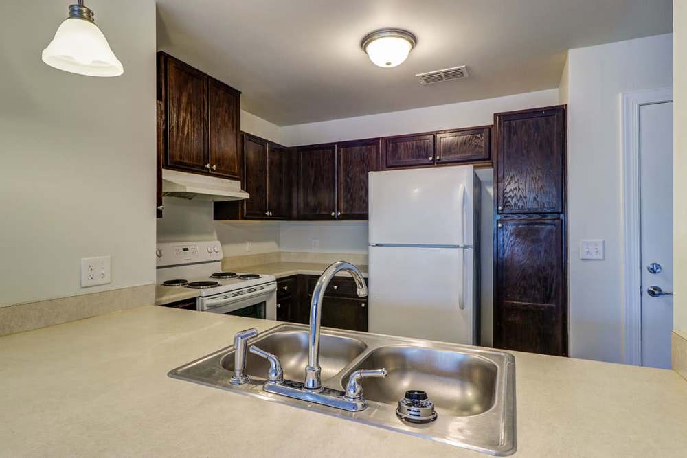 Granite countertops and wooden cabinets in kitchen at Fellwood III in Savannah, Georgia