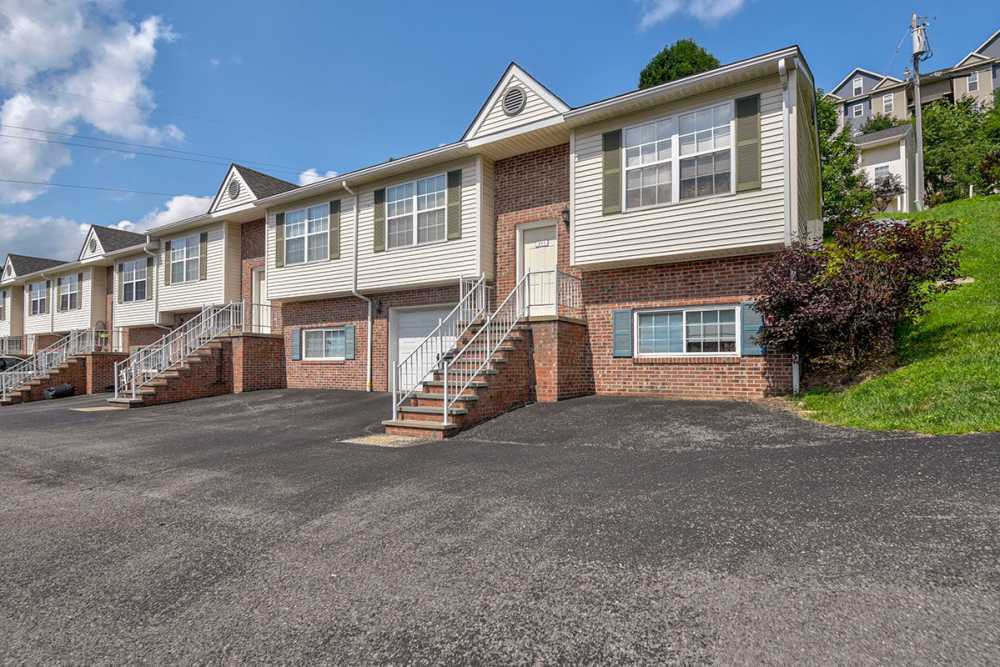 Apartment with concrete stairs and metal railings leading to a front door at Greene Glen in Morgantown. WV