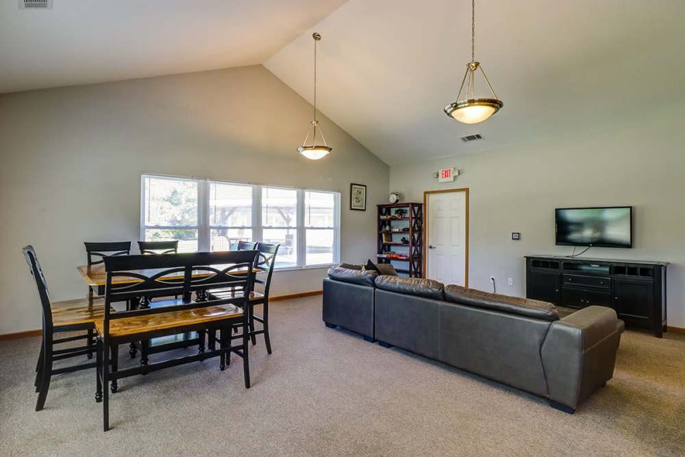 Living space and dining table in the clubhouse at Harmony Greene in Pooler, Georgia