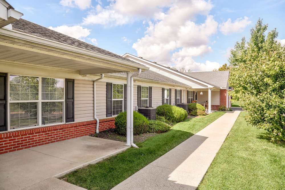 Gated entrance with landscaped pathways and spacious outdoor areas in a pet-friendly apartment community at Heritage Greene in Washington Court House, Ohio