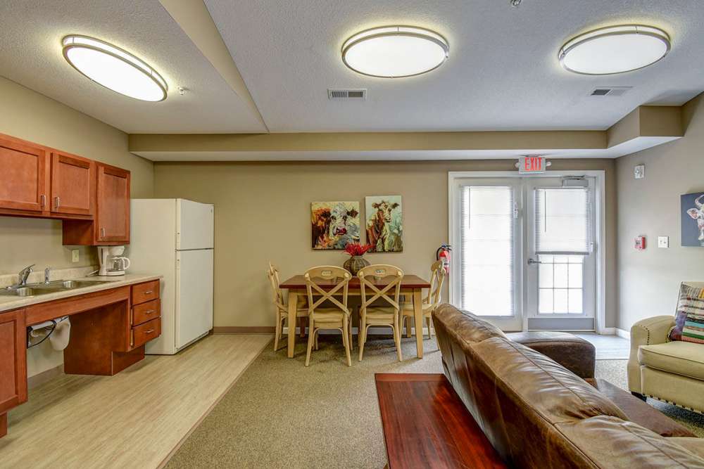 Open layout living area with kitchen, dining table, and cozy seating area at Oak Valley Gardens in Glenville, West Virginia
