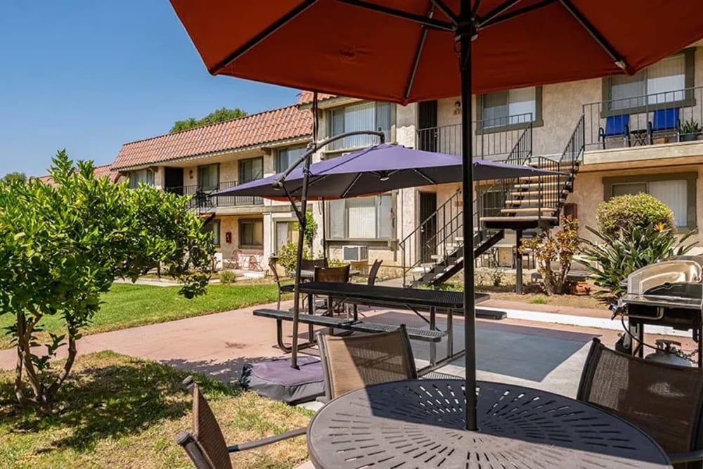 Outdoor area with umbrellas at Valley Pride Village in Sylmar, California