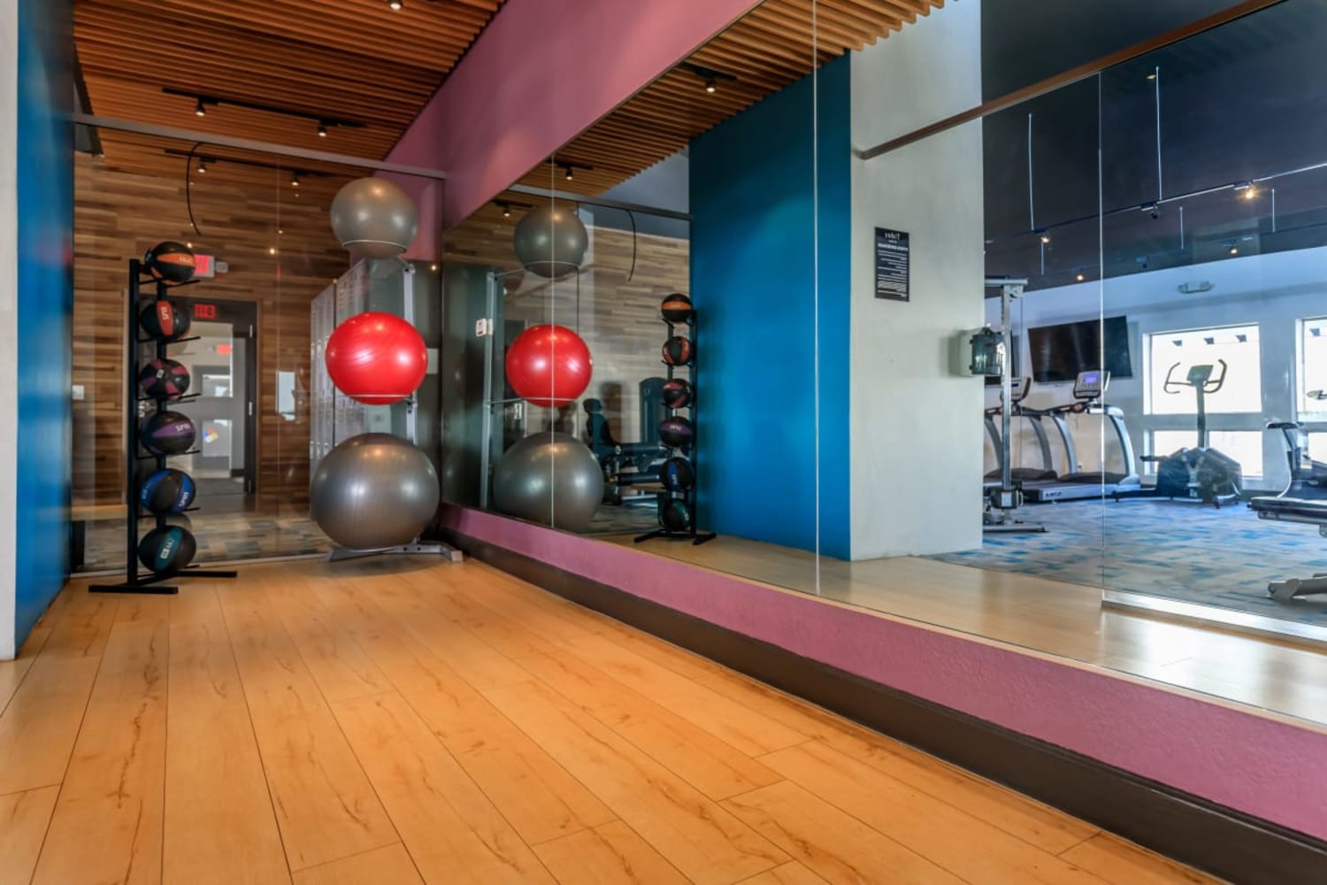 Exercise balls and wood floors in the fitness center at Station 21 Apartments in Mesa, Arizona
