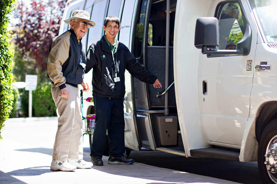 Staff and resident boarding a shuttle at Palo Alto Commons in Palo Alto, California