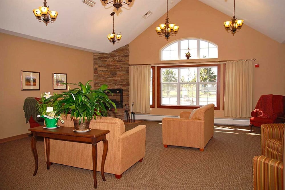 Comfortable seating area with large windows at Milestone Senior Living Eau Claire in Eau Claire, Wisconsin.