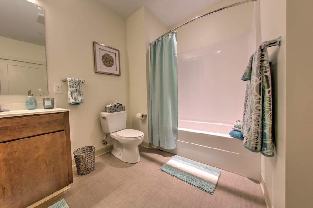 Spacious bathroom with commode and standard bathtub at Gateway North in Lynn, Massachusetts