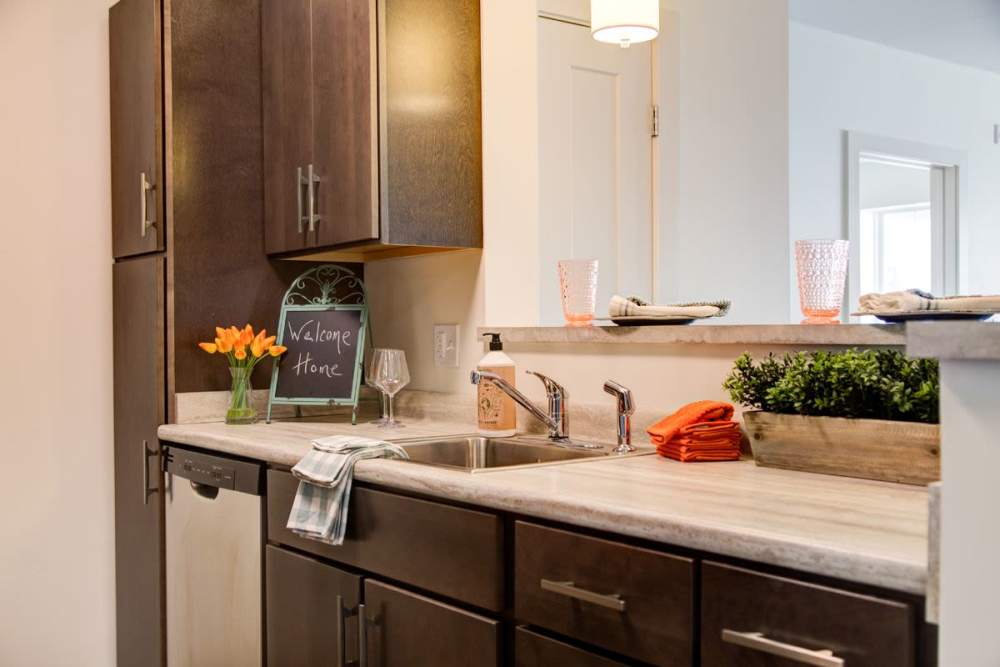 Kitchen with stainless-steel sink and wood cabinet at Gateway North in Lynn, Massachusetts