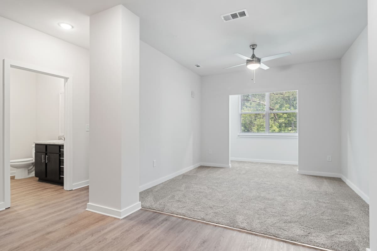 Apartment living room with a ceiling fan at Peachtree Creek on Ponce in Clarkston, Georgia