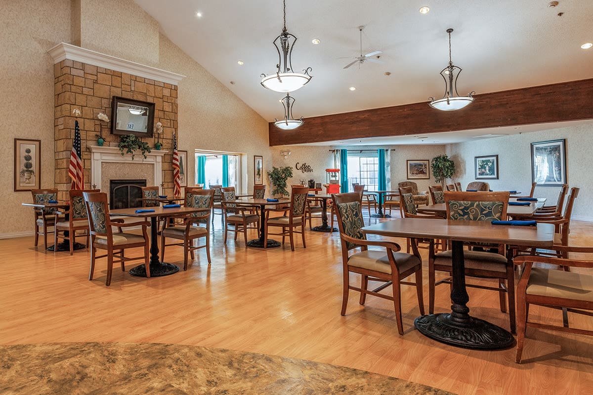 Dining room with seating and fireplace at Trustwell Living at Oak Creek Place in South Milwaukee, Wisconsin