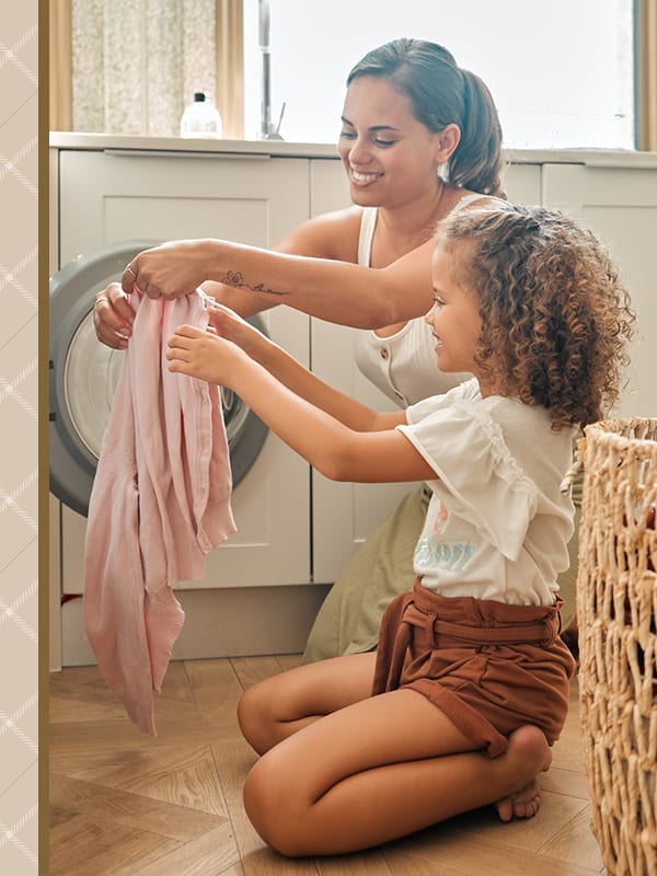 Mother and daughter doing some laundry in their new home at The Mallory in Raleigh, North Carolina