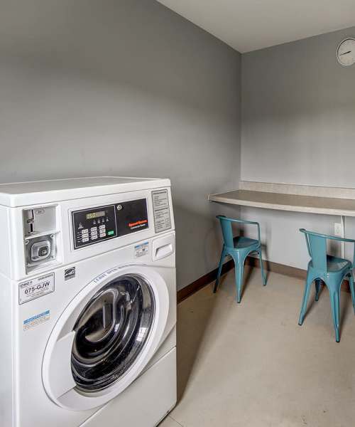Laundry room with washer and seating area at Butler Crossing I in Kingstree, South Carolina