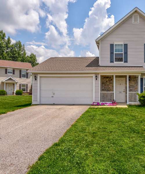 Garage door with stone accents and flowers at Orchard Glen in Orrville, Ohio