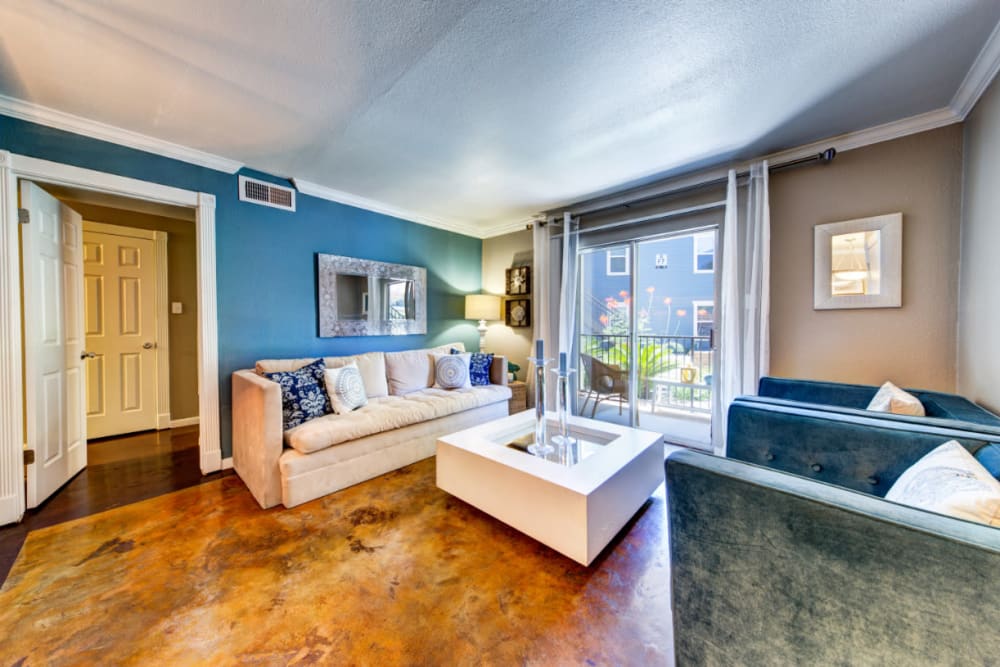 Bright and open living room with access to private balcony seating area at Austin Midtown in Austin, Texas