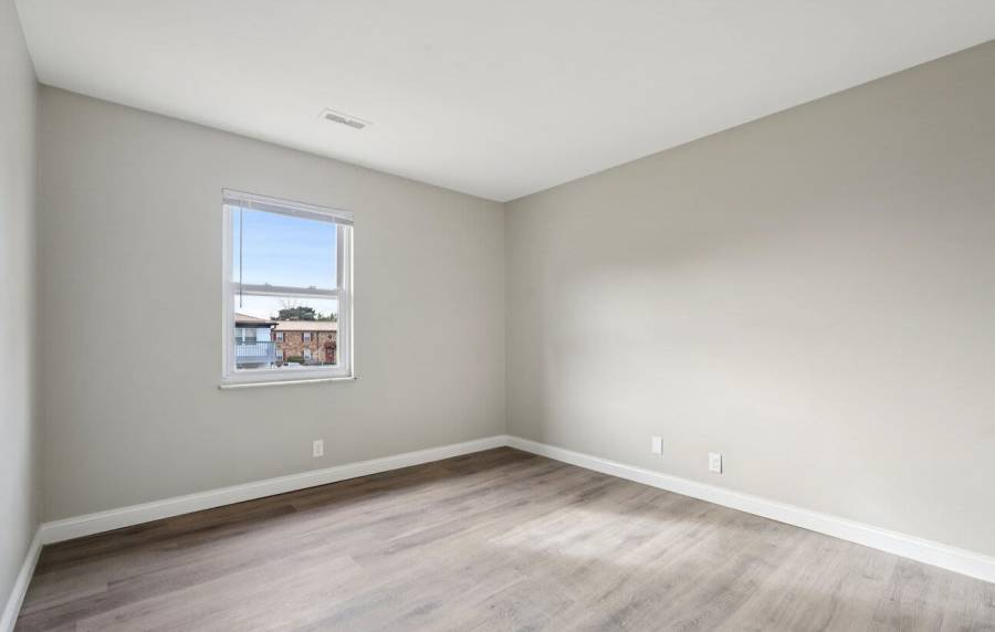 Unfurnished bedroom having wooden flooring at Charleston Square Apartments in Columbus, Indiana