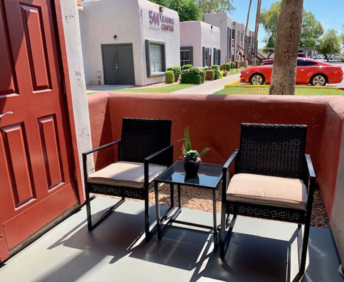 Private balcony with chairs and view of community at 544 Southern Apartments in Mesa, Arizona