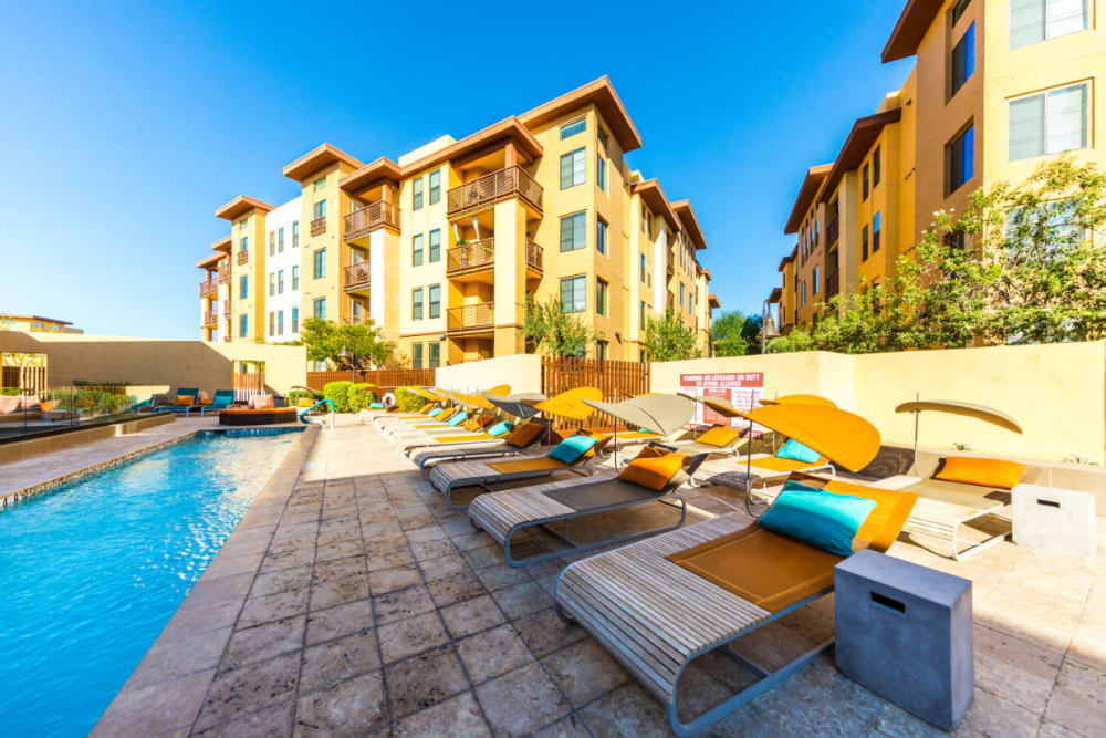Swim lane surrounded by lounge chairs at Marquis at Desert Ridge in Phoenix, Arizona