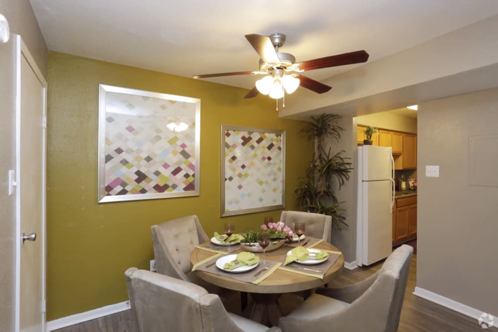 Model dining room with view of kitchen at EnVue Apartments in Bryan, Texas