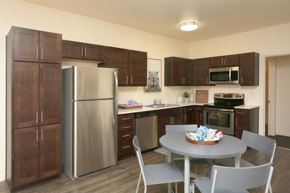 Kitchen with stainless-steel appliances in an apartment at Cedar Flats in Chico, California