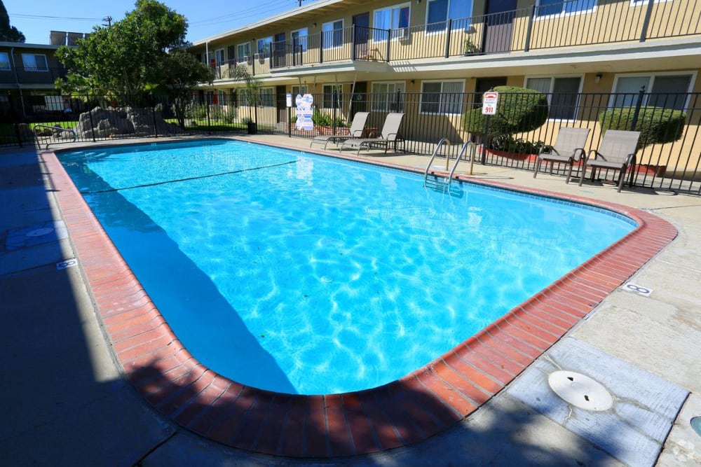 Chaise lounge chairs by the pool at Royal Gardens Apartment Homes in Livermore, California