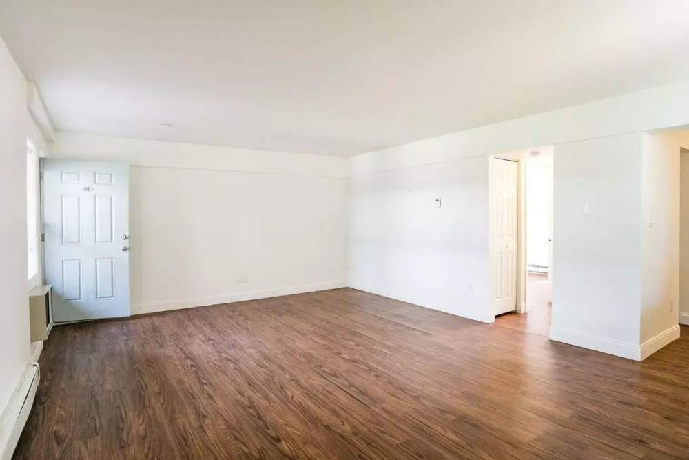 Open layout living room with hard-wood style flooring at Detroit Living in Detroit, Michigan
