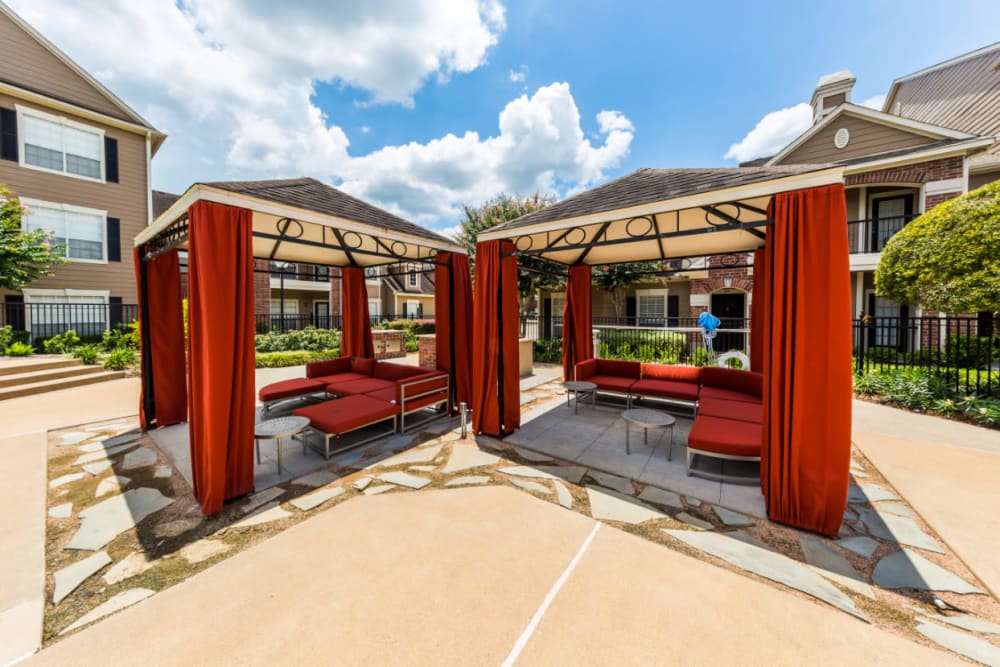 Gazebos with lounge couches and side tables at Marquis on Park Row in Houston, Texas