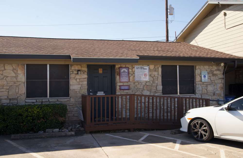 Charming stone facade with welcoming front porch and parking area at Daffodil in Austin, Texas