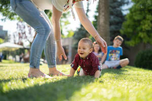 Child crawling on the grass at Wythe Apartment Homes in Irving, Texas