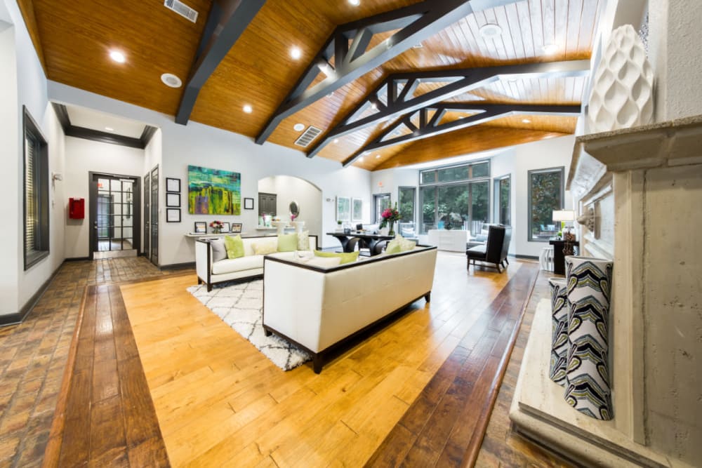 Modern and bright community clubhouse sitting area with wood flooring at Marquis at Kingwood in Kingwood, Texas