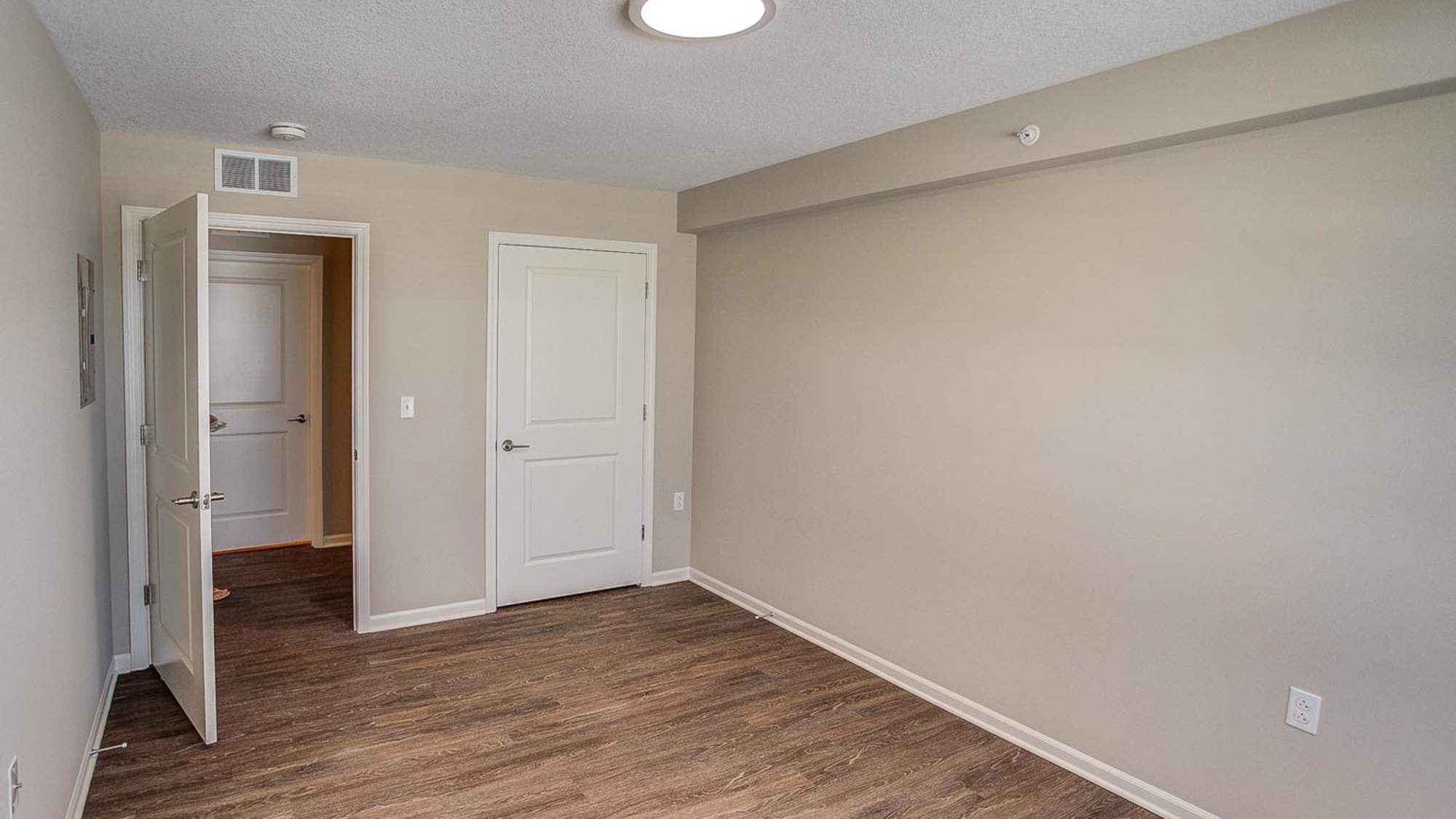 Bedroom with wood flooring at McKay Manor in Breese. IL