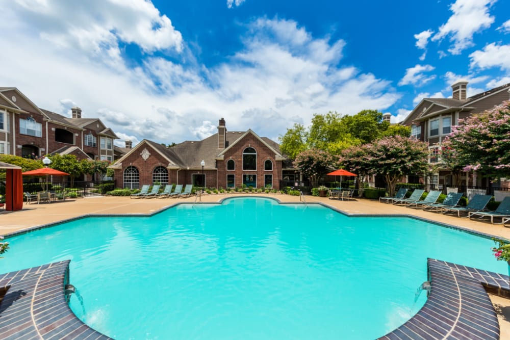 Sparkling pool with water features overlooking clubhouse at Marquis on Park Row in Houston, Texas