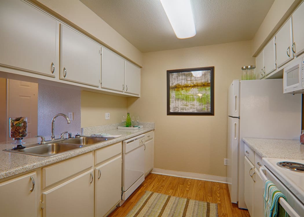 Kitchen with white cabinets at Granada Villas Apartment Homes in Lancaster, California