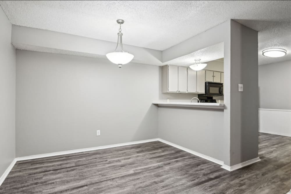Modern apartment dining space next to the kitchen at Courts of Bedford in Bedford, Texas