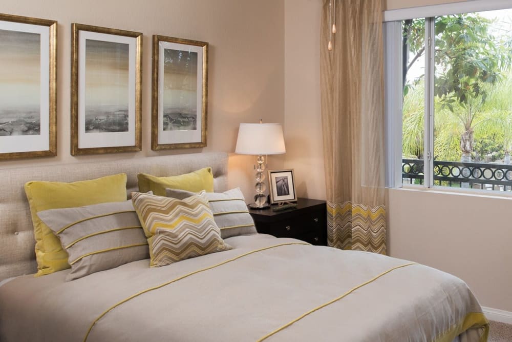 Main bedroom with a large window at Alize at Aliso Viejo Apartment Homes in Aliso Viejo, California