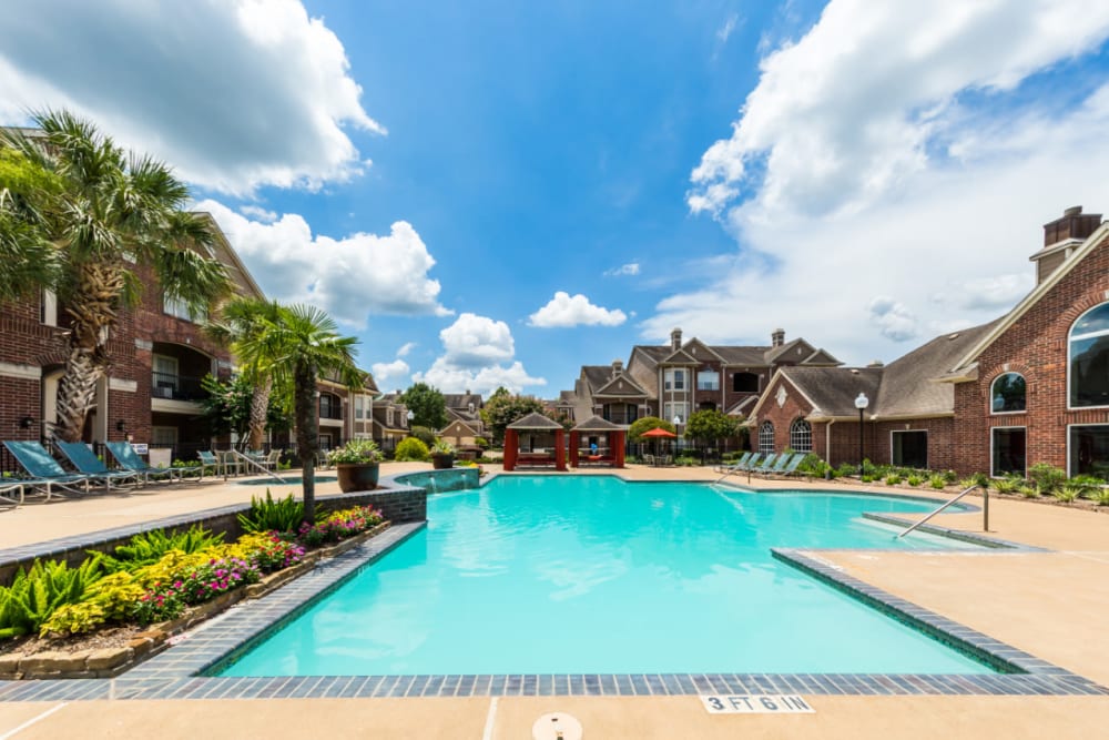 Sparkling pool with water features overlooking gazebos at Marquis on Park Row in Houston, Texas