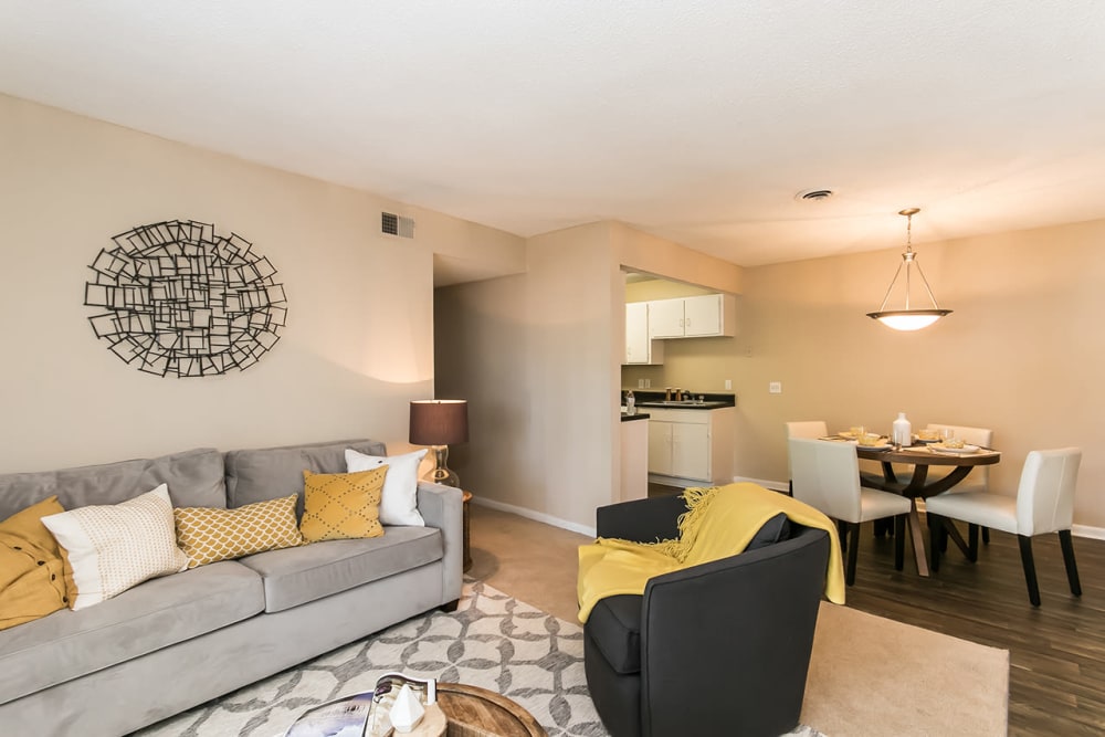 Model living room and dining area with wood-style flooring at Forestbrook Apartments and Townhomes in West Columbia, South Carolina