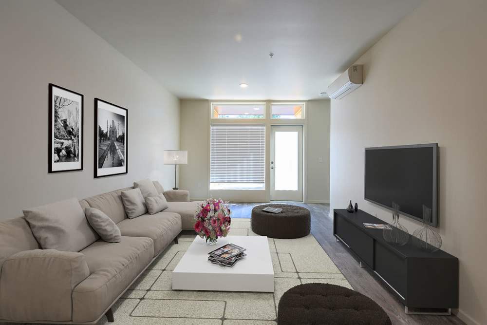 Living room with wood flooring and television at Edison Apartments in Gresham, Oregon