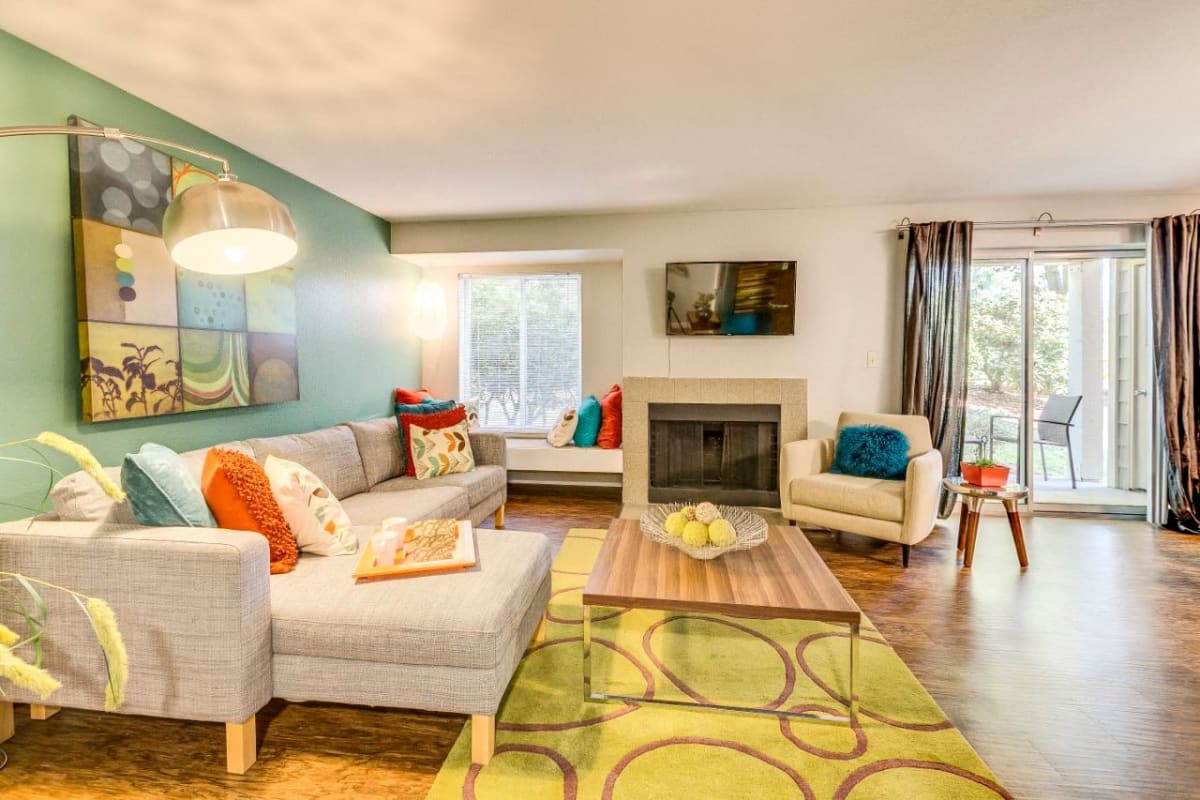 An apartment living room with a fireplace at MonteVista in Beaverton, Oregon