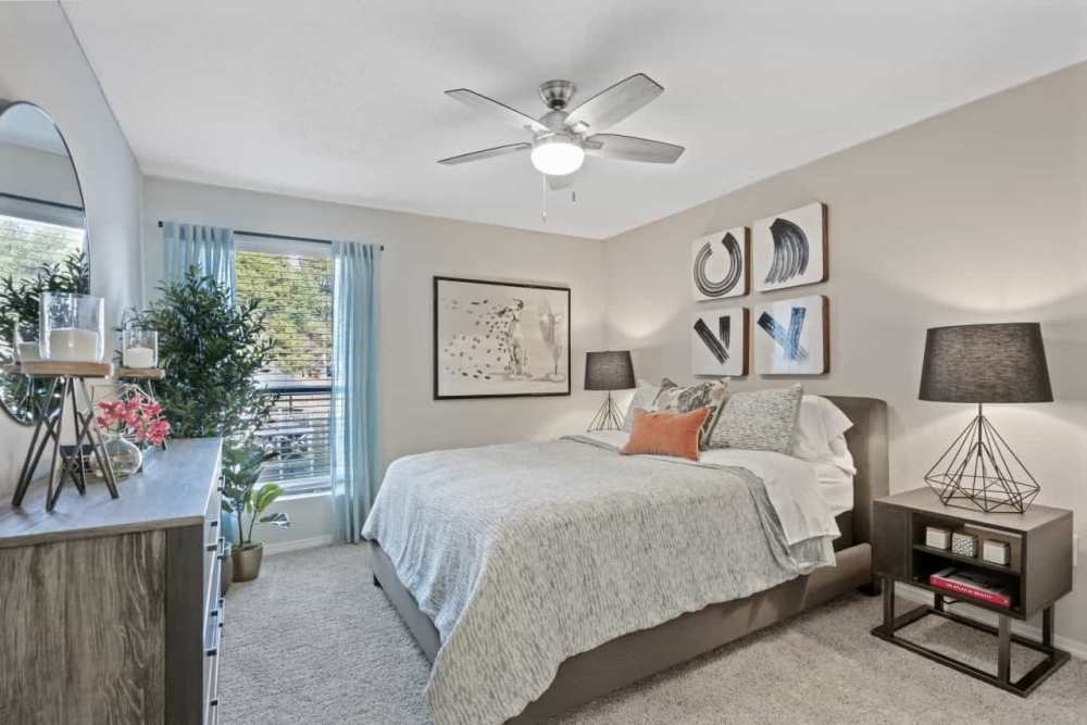 Bedroom with window and lamp light at Andover at Crabtree in Raleigh. NC