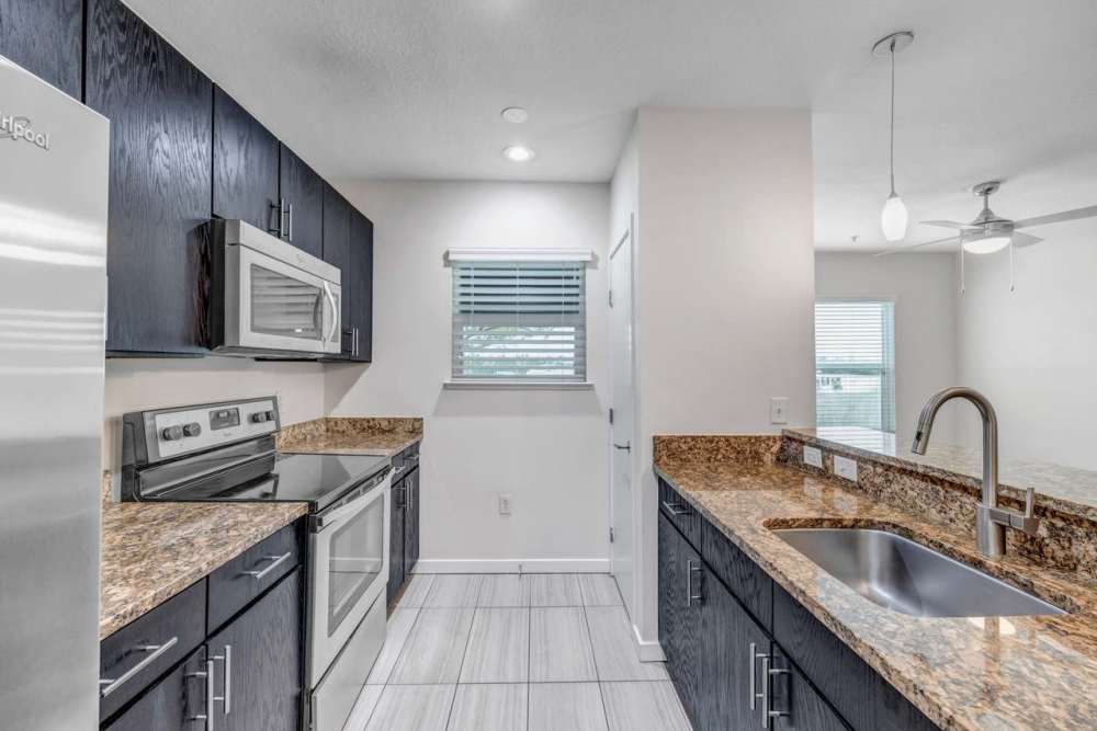 Kitchen with wooden cabinets at Citrus Run Apartments in Tampa, Florida