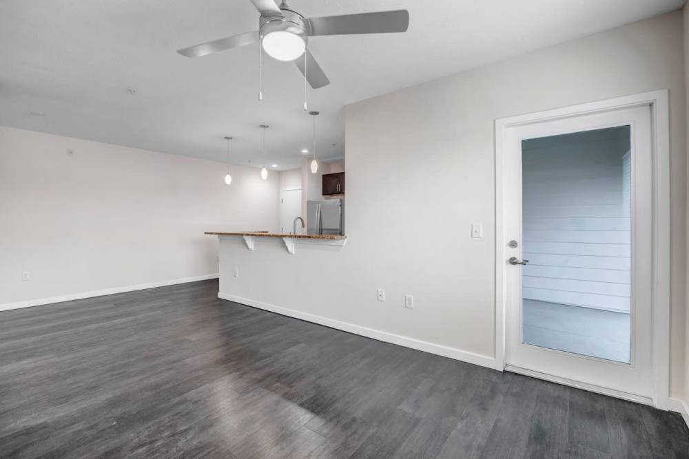 Spacious living room with view of kitchen at Citrus Run Apartments in Tampa, Florida
