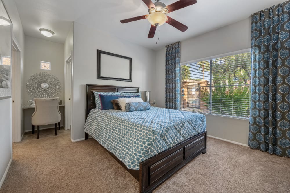 Cozy bedroom with large window and seating area at Alante at the Islands in Chandler, Arizona