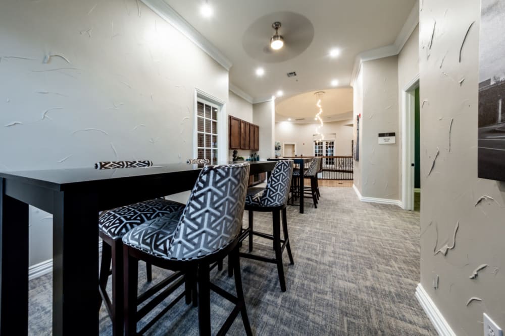 Community clubhouse dining area with multiple tables and chairs at Marquis at Stone Oak in San Antonio, Texas