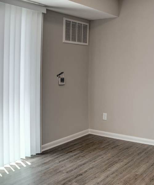 Access to private balcony from living area with air conditioning at Bell Diamond Manor in Norfolk, Virginia