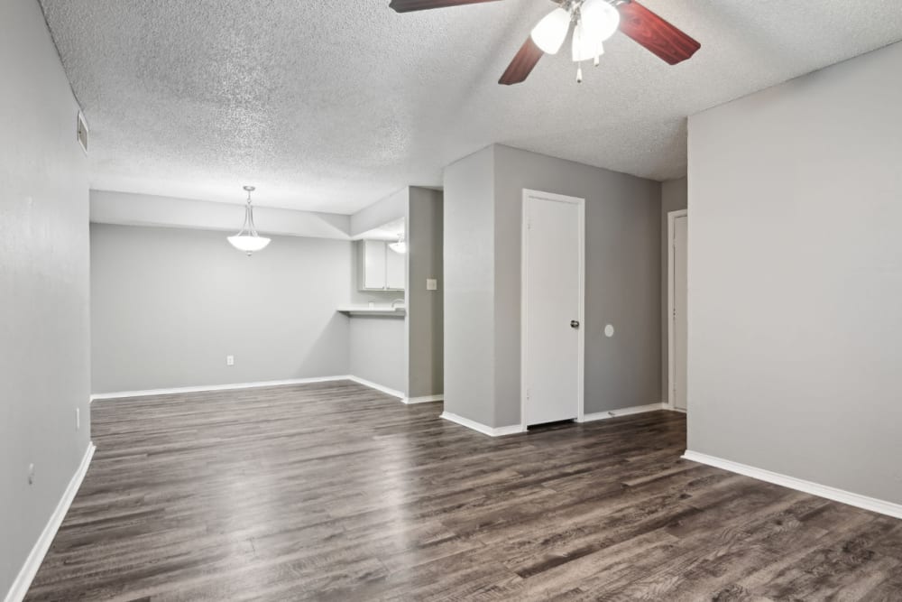 Wood style floored apartment with ceiling fan at Courts of Bedford in Bedford, Texas