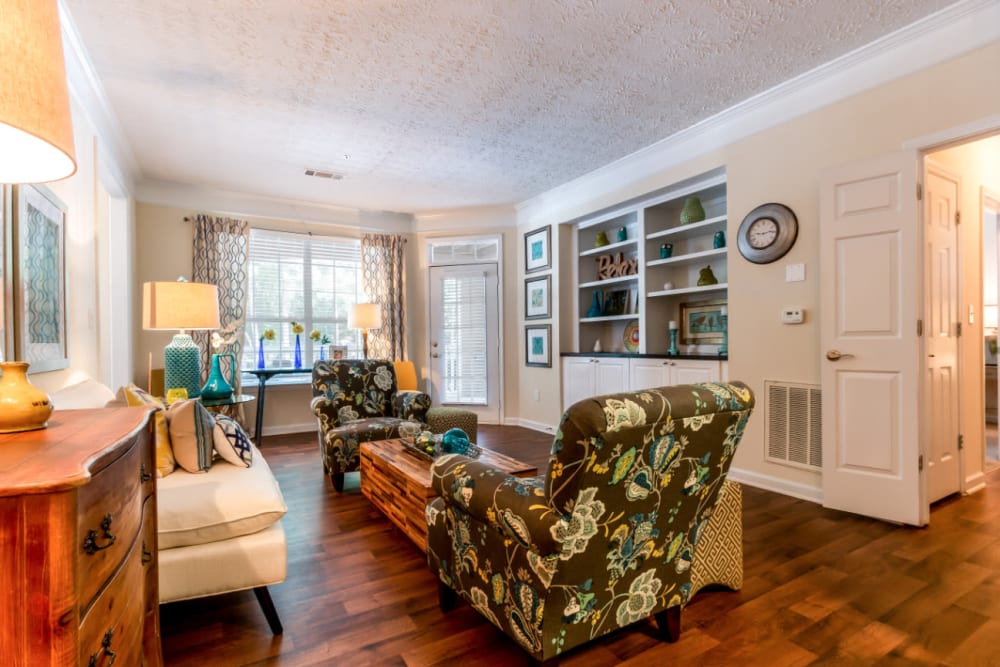 Bright kitchen with wood flooring and stainless steel appliances overlooking living area at Marquis at Sugarloaf in Duluth, Georgia
