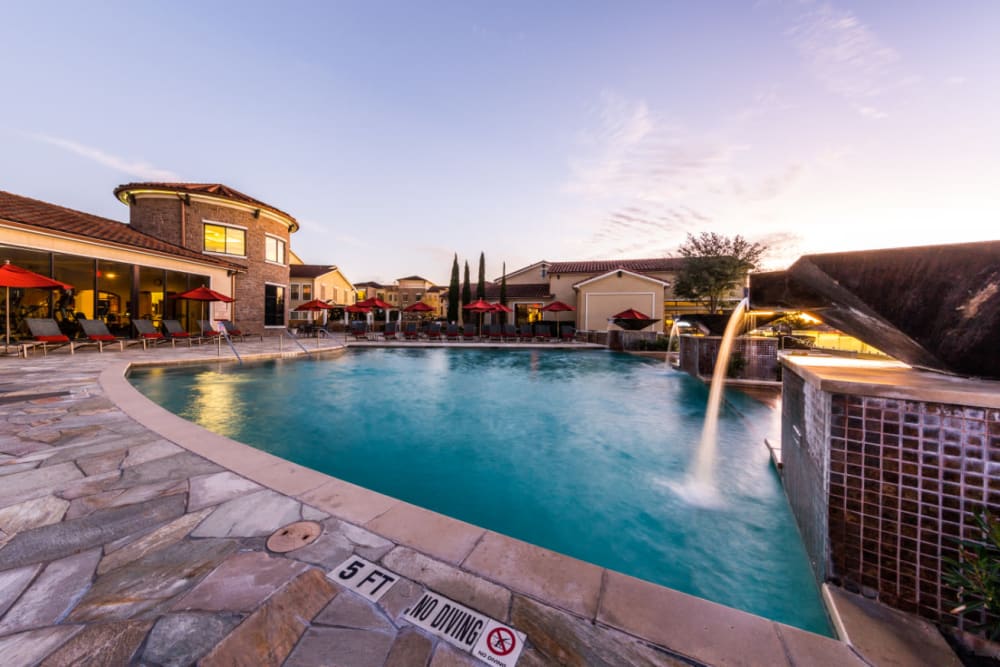 Sparkling pool with waterfall feature at Marquis at the Reserve in Katy, Texas